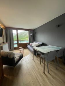 a living room with a table and a couch at Le 1888 Val d'Isère in La Daille