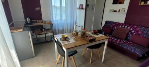 a small living room with a table and a couch at ~ Parenthèse bucolique ~ in Saint-Germain