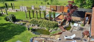 an aerial view of a garden with a swimming pool at Étang des Tamaris in Namur