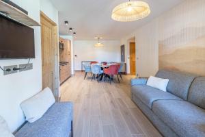 a living room with a couch and a table at SmartStay - Super Morzine in Morzine