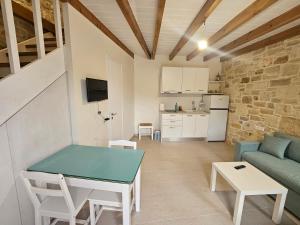 a living room with a table and a couch at Gem apartment Analipsi in Hersonissos