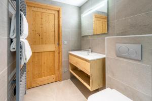 a bathroom with a sink and a mirror at SmartStay - Super Morzine in Morzine +36 photos