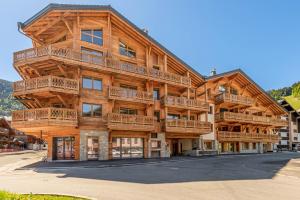 a large wooden building with balconies on it at SmartStay - Super Morzine in Morzine