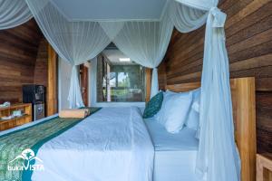 a bedroom with a bed with a canopy at Pondok Nini Bungalow by Bukit Vista in Ubud +18 photos