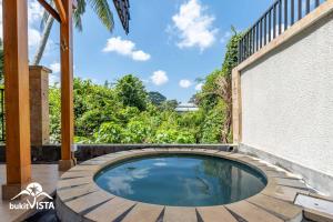 a small pool in the middle of a patio at Pondok Nini Bungalow by Bukit Vista in Ubud