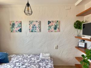 a room with four paintings on the wall at Estudio en el Castillo de Denia in Denia