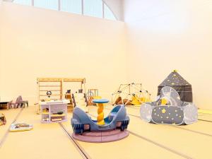 a play room with a slide and a playground at Palcall Tsumagoi Resort Ski & Hotel in Tsumagoi