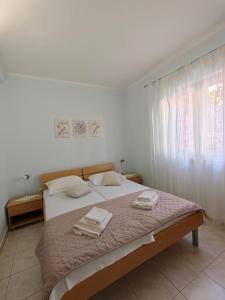 Postel nebo postele na pokoji v ubytování Apartments Maskovic Karbuni