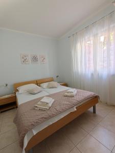 Postel nebo postele na pokoji v ubytování Apartments Maskovic Karbuni