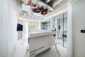 a bathroom with a mirror and a sink and a tv at Stellar Boutique Modules by Maistra City Vibes in Zagreb