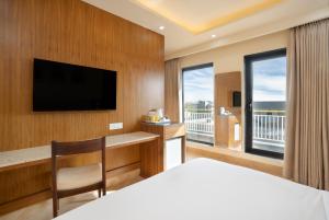 a hotel room with a bed and a flat screen tv at Bloom Boutique l Sector 45 Gurugram in Gurgaon