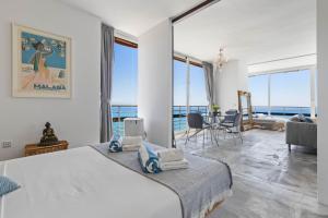 a bedroom with a large bed with a view of the ocean at Casa Sol - Impresionantes vistas al mar in Torremolinos +36 photos