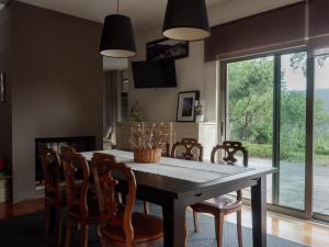 a dining room with a table and chairs at Tapada do Sobral in Vilar de Ferreiros