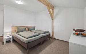 a bed in a room with a white wall at 1 Bedroom Nice Apartment In Oberhof in Oberhof