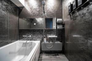 a bathroom with a tub and a shower and a sink at 88 Matsui Building Sapporo in Sapporo +112 photos