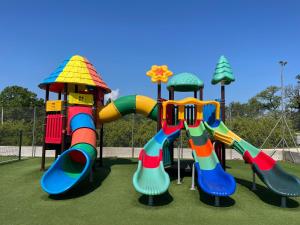 a playground with two slides and a play structure at Camping La Combe in Barjac