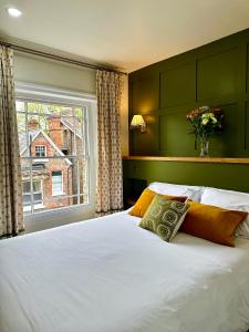 a bedroom with a large white bed with a window at 23 St Mary's in York