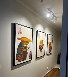 a group of framed pictures on a wall at The Ryrie Loft in Geelong