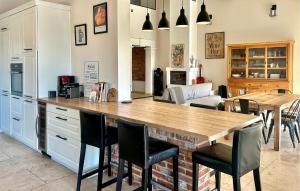 a kitchen with a wooden table and chairs at Maison Avec Piscine Privée in Châteauneuf-du-Pape
