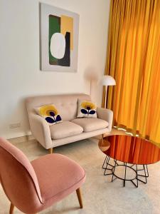 a living room with a couch and a table at 1BR condo with Amazing KLCC View & Infinity Pool at Lalaport Bukit Bintang in Kuala Lumpur +74 photos