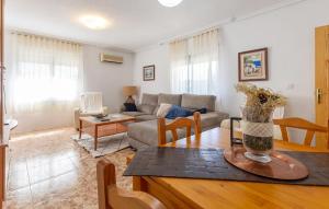 a living room with a couch and a table at 3 Bedroom Amazing Home In Los Alcazares in Los Alcázares