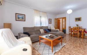 a living room with a couch and a table at 3 Bedroom Amazing Home In Los Alcazares in Los Alcázares