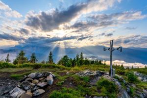 a cross on top of a hill with mountains in the background at Appartements Hochzillertal in Kaltenbach