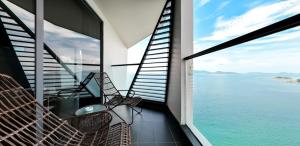 a balcony with chairs and a view of the water at Boton Blue Hotel & Spa in Nha Trang