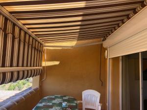 a room with a table and a chair on a porch at Paraíso in Cumbre del Sol
