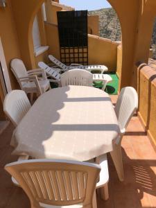 a white table and chairs on a balcony at Paraíso in Cumbre del Sol
