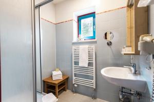 a bathroom with a sink and a shower at JUFA Hotel Maria Lankowitz am See in Maria Lankowitz +62 photos