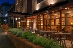 a restaurant with tables and chairs outside at night at Hotel Estel in Berga