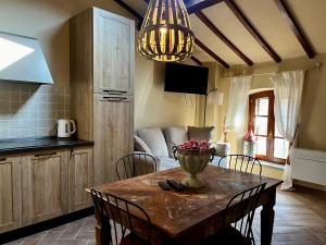 a kitchen and dining room with a table and chairs at Il Girasole in Chianni