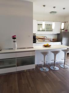 a kitchen with a white counter and a table at Apartments Tereza in Senj