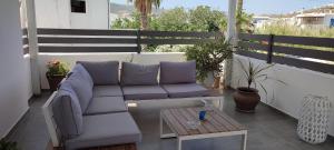 a couch and a coffee table on a balcony at Maria Studios in Parikia