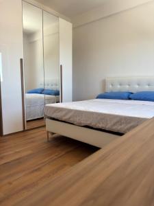 a bedroom with a large bed and a mirror at Sul Mare - da Angelica in Termoli