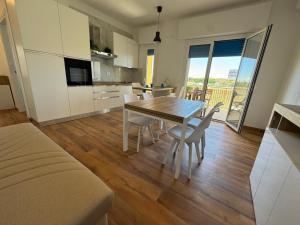a kitchen and dining room with a table and chairs at Sul Mare - da Angelica in Termoli +39 photos