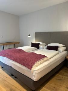 A bed or beds in a room at Dining & Living Alpenrose