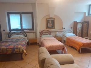 A bed or beds in a room at B&B Villa Bucceri