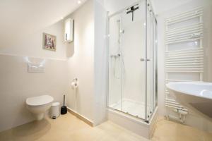 a bathroom with a shower and a toilet and a sink at Kleiner Glücksort in Gillenfeld +13 photos