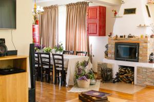 a dining room with a table and a fireplace at Pensiunea Tania-Nora in Alexandru cel Bun 