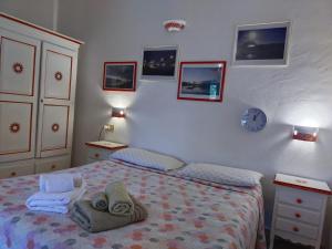 a bedroom with a bed and a clock on the wall at B&B La Taerra in Porto San Paolo