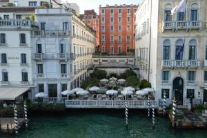 a bridge with umbrellas in the water between buildings at The St. Regis Venice in Venice