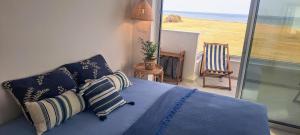 a bedroom with a bed with a view of the ocean at Blue Aura Beach villa Larnaca in Pervolia +95 photos