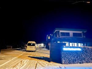 a van parked next to a house in the snow at Moonbay Beach Villa in Lake Toya