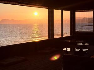 a room with a view of the ocean at sunset at Moonbay Beach Villa in Lake Toya