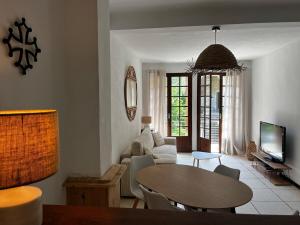 a living room with a table and a couch at La Maison de Faustin in Saint-Guilhem-le-Désert