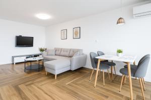 a living room with a couch and a table at South Panoramic Apartment in the art district of Kapana in Plovdiv
