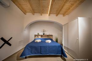 a bedroom with a bed with two towels on it at Borgo La Chiusa in Castellammare del Golfo