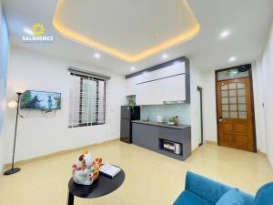 a living room with a tv and a couch and a table at Dapano Maison in Hanoi